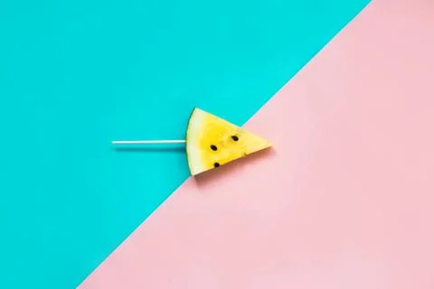 Triangular ice cream slices on a stick of ripe yellow watermelon Stock Photos