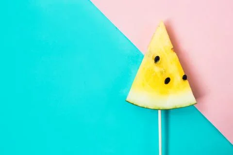 Triangular ice cream slices on a stick of ripe yellow watermelon 스톡 사진