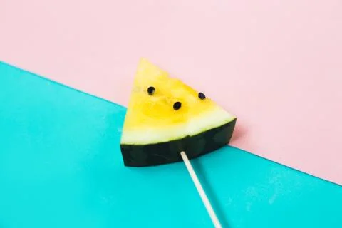 Triangular ice cream slices on a stick of ripe yellow watermelon Stock Photos