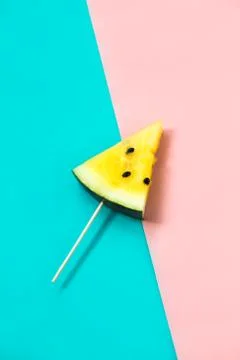 Triangular ice cream slices on a stick of ripe yellow watermelon 스톡 사진