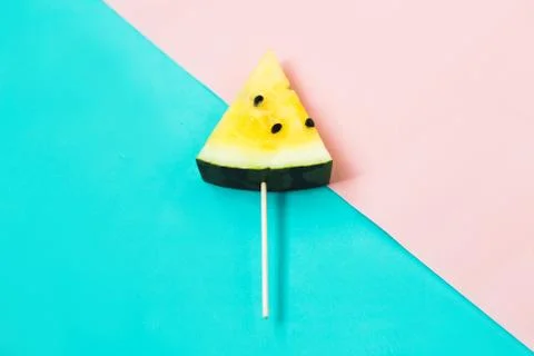Triangular ice cream slices on a stick of ripe yellow watermelon 库存照片