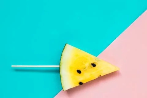 Triangular ice cream slices on a stick of ripe yellow watermelon Foto stock