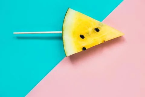 Triangular ice cream slices on a stick of ripe yellow watermelon Stock Photos