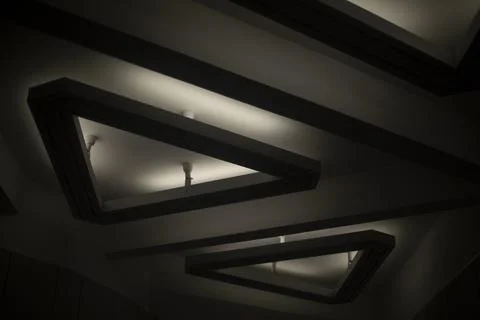 Triangular lamp on ceiling. Interior details. Light in hall. 스톡 사진