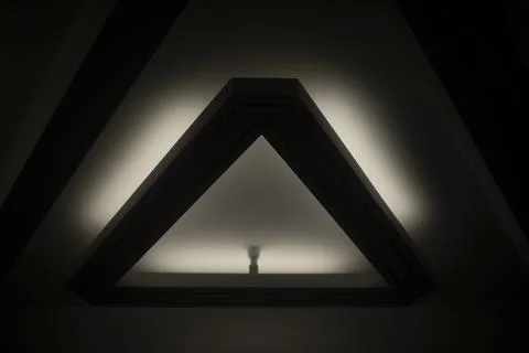 Triangular lamp on ceiling. Interior details. Light in hall. Foto stock