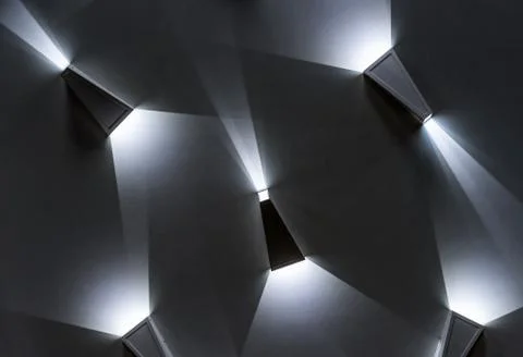 Triangular LED lamps with a white glow. LED lighting in the interior. 스톡 사진