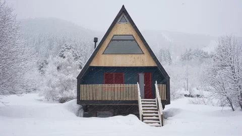 Triangular modern wooden house in winter in the snowy mountains. Country house Stock Footage 270358987