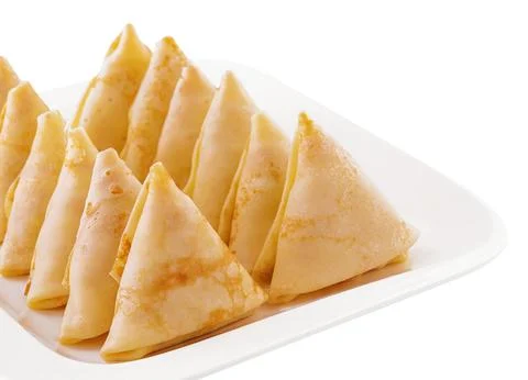 Triangular pancakes with meat on plate Stock Photos