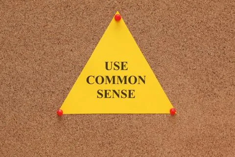 Triangular paper note with the words "use common sense" Stock Photos