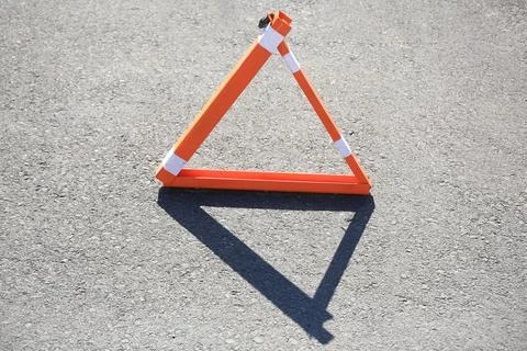 Triangular parking barrier on asphalt road outdoors Foto stock