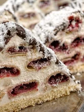 Triangular pastries with burgundy fruit jam filling, covered with chocolate.. Stock Photos