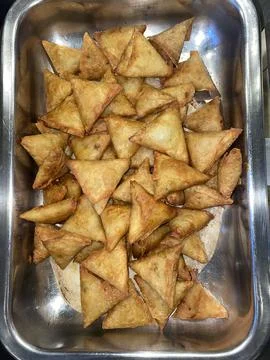 Triangular pastry is full of vegetable. Stock Photos