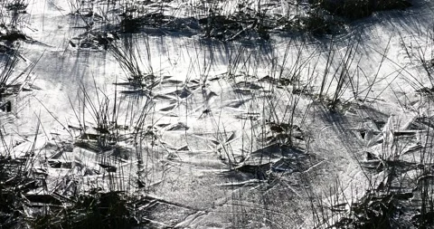 Triangular patterns in frozen floodwater on a watermeadow in Ambleside, Lake  Stock Footage 239573075