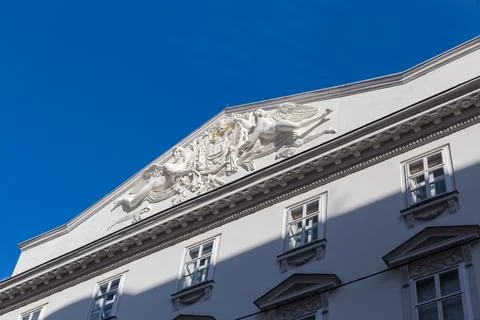Triangular pediment  of building with sculptures and stucco, Vienna Stock Photos