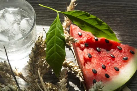 A triangular piece of sweet watermelon on an ice cream shelf, a cold drink wi Stock Photos