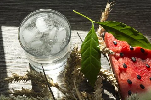 A triangular piece of sweet watermelon on an ice cream shelf, a cold drink wi Stock Photos