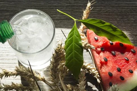 A triangular piece of sweet watermelon on an ice cream shelf, a cold drink wi Stock Photos