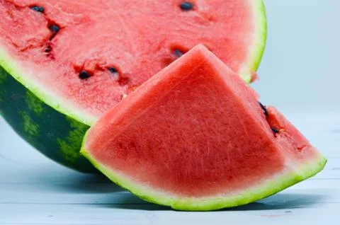 Triangular piece of watermelon and cut in half a watermelon Stock Photos