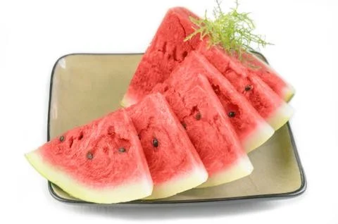 Triangular pieces of red ripe watermelon on a plate. Close up Stock Photos