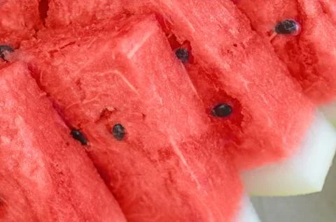 Triangular pieces of red ripe watermelon on a plate. Close up. Background Stock Photos