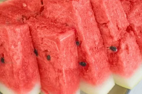Triangular pieces of red ripe watermelon on a plate. Close up. Background Stock Photos