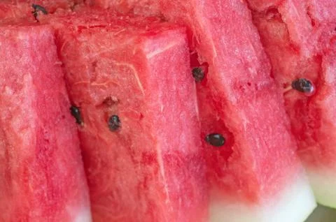 Triangular pieces of red ripe watermelon on a plate. Close up. Background Stock Photos