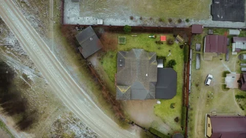 A triangular plot of land fenced with a fence, on which stands a brick house Video stock 218403910