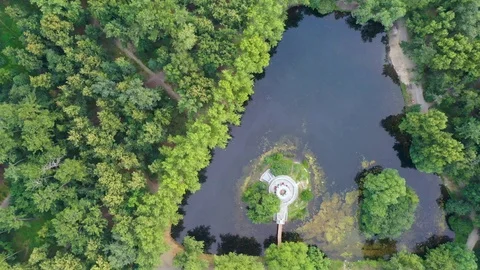 Triangular pond with gazebo top view of a smoother ride the camera along the 스톡 동영상 112877828
