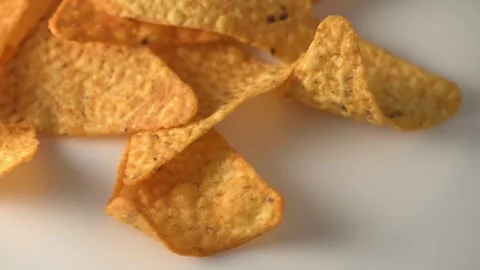 Triangular potato chips with seasoning rotating, flavored crunchy snack Stock Footage 327579728
