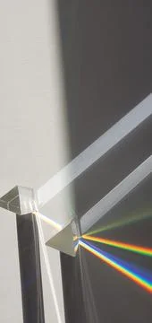 Triangular prism in sunlight with rainbow lines Stockfoto's