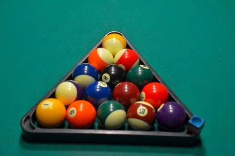 Triangular rack of colorful billiard balls Фото