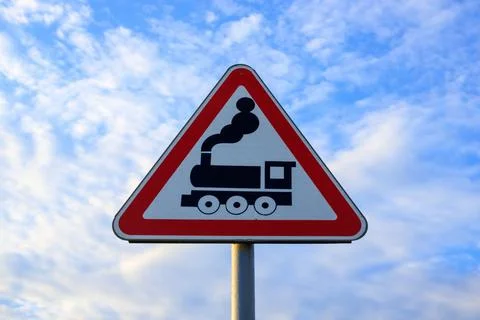 Triangular railway crossing road sign with steam locomotive icon, warning t.. Stock Photos
