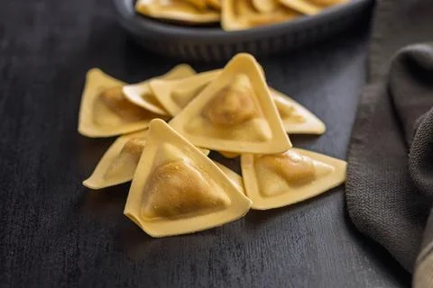 Triangular Ravioli Pasta Close-Up on Dark Surface Uncooked Filled Italian D.. 스톡 사진