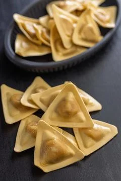 Triangular Ravioli Pasta Close-Up on Dark Surface Uncooked Filled Italian D.. Fotos de archivo