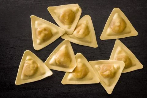 Triangular Ravioli Pasta Close-Up on Dark Surface Uncooked Filled Italian D.. Fotos de archivo