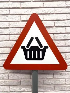 Triangular red and white sign with shopping basket icon indicates the location Foto stock