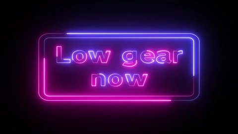 Triangular road caution sign with low gear now sign. Neon triangle warning .. Stock Footage 296490274