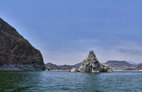 Triangular rock in the middle of the dam Photos