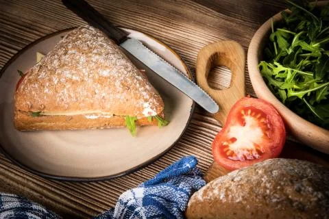 Triangular sandwich with cheese, ham and tomato. Stock Photos