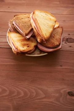 Triangular sandwiches on wooden table Stock Photos