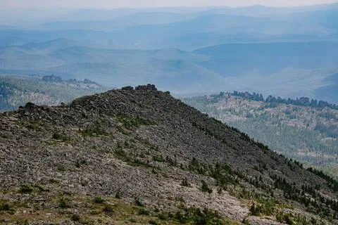 Triangular shaped mountain and hills stretching into the distance to the ho.. 스톡 사진