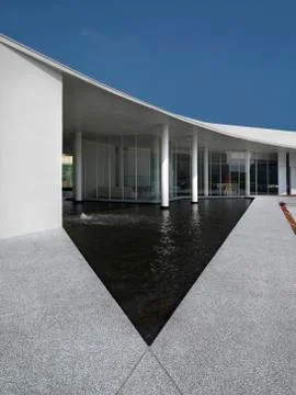 Triangular shaped pool outside modern building Stock Photos