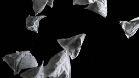Triangular shaped tea bags against a black background in slow motion Stock Footage 182768578