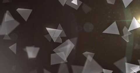 Triangular shards appearing then drifting and rotating over dark field, creating Stock Footage 329575936