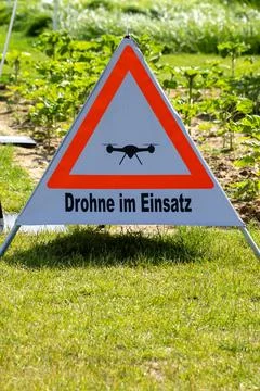 A triangular sign with a drone on it Stock Photos