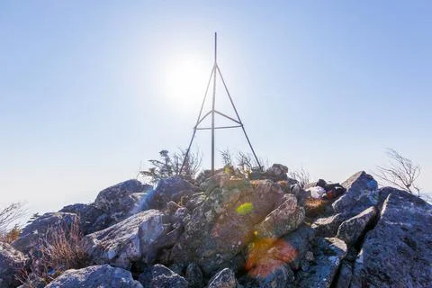 The triangular sign stands on a rocky ridge in the Primorsky Territory. Autum Stock Photos