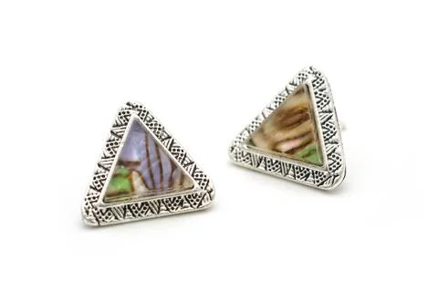 Triangular silver earrings with marble isolated on white 库存照片