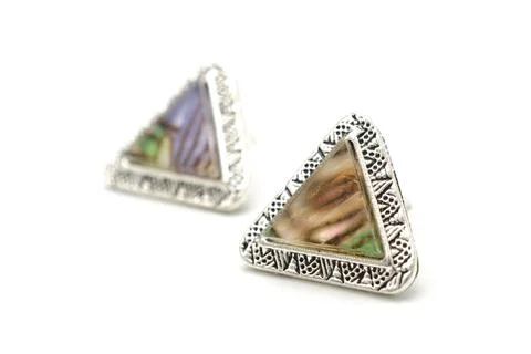 Triangular silver earrings with marble isolated on white Stockfoto's