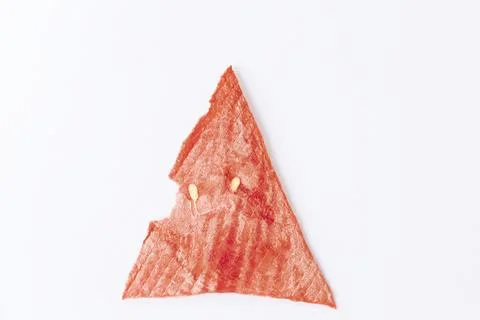 Triangular slice of dried red, ripe watermelon. fruit chips on a white backgr Stock Photos