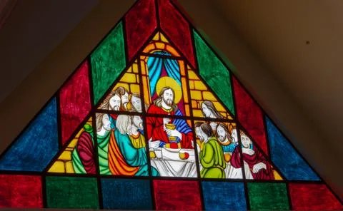 Triangular Stained Glass Window Depicting Jesus and the Twelve Disciples Stock Photos
